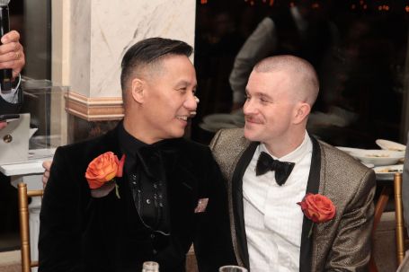 wong with his husband wearing tux 